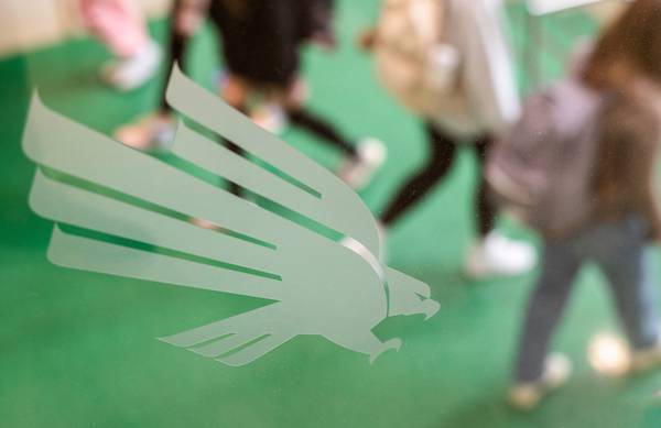 UNT's diving eagle logo on a glass door in the Student Union