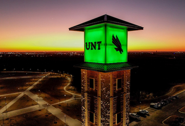 UNT at Frisco tower lit up at dusk